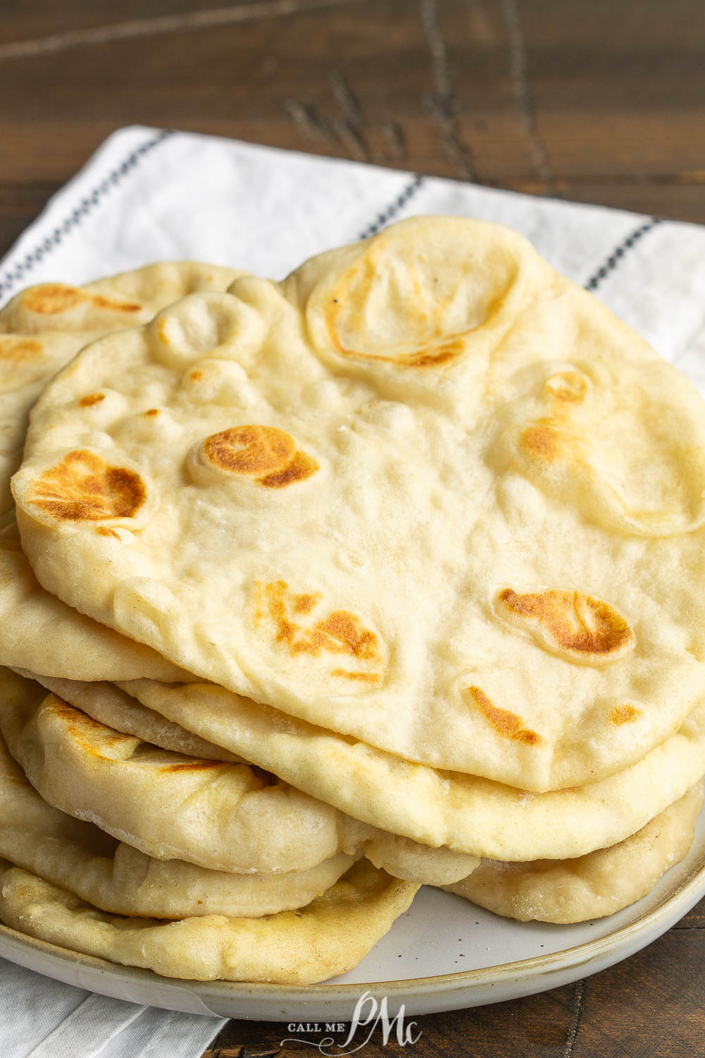 Herbed Garlic Butter Naan is soft, buttery, and delicious.  If you're new to working with yeast, this recipe is easy and only takes a 1 hour to proof and 3 minutes to cook! #naan #garlic #butter #bread #pita #flatbread #recipe