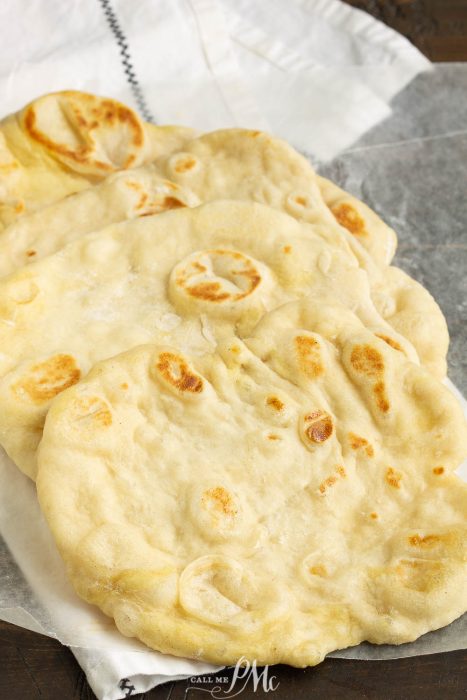 Herbed Garlic Butter Naan is soft, buttery, and delicious.  If you're new to working with yeast, this recipe is easy and only takes a 1 hour to proof and 3 minutes to cook! #naan #garlic #butter #bread #pita #flatbread #recipe