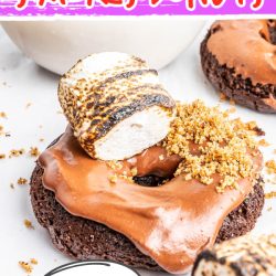 The delicious S'mores Doughnuts Recipe starts with a quick mix, then baked, and topped with a chocolate glaze, a toasted marshmallow, and crushed graham crackers. They are soft, sweet, and decadent.