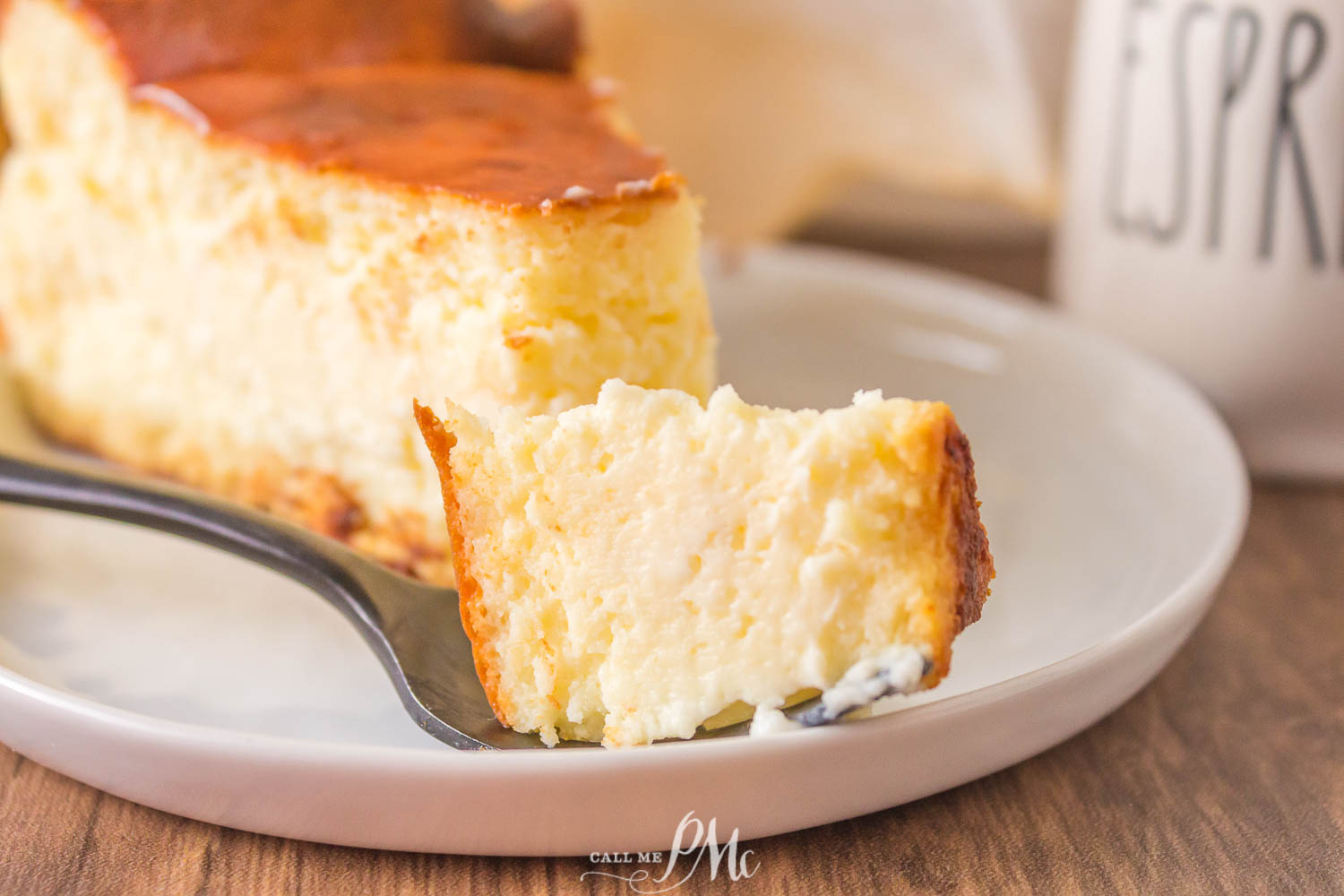 A Bite of Basque Cheesecake on a fork on a plate.