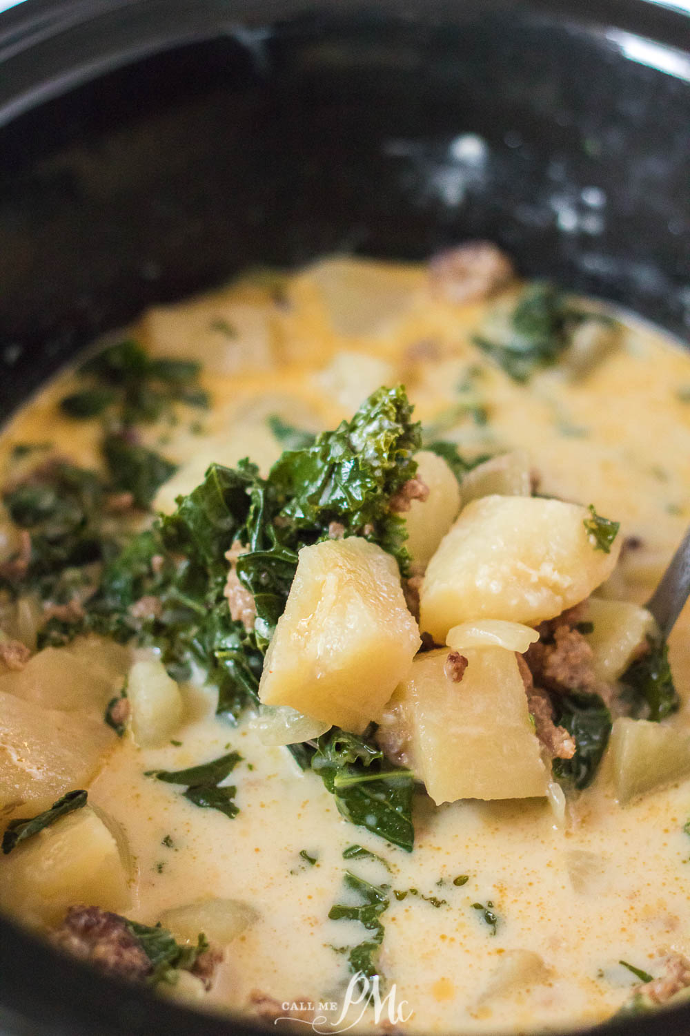 A Slow Cooker Zuppa Toscana soup with potatoes and kale.