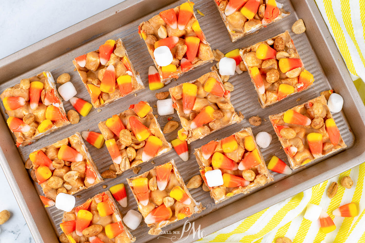 Copycat PayDay candy corn marshmallow bars cut into squares on a baking sheet.