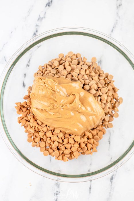 bowl of butterscotch chips topped with creamy peanut butter.