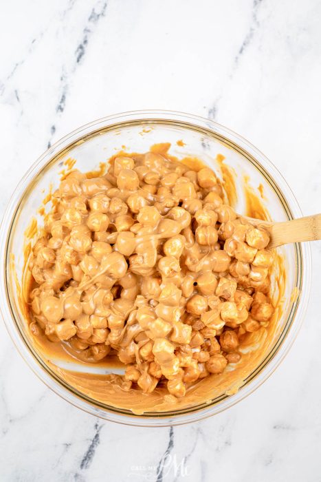 wooden spoon combining candy ingredients in a bowl.