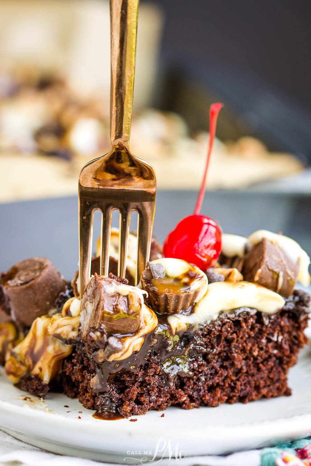 fork standing in slice of chocolate poke cake