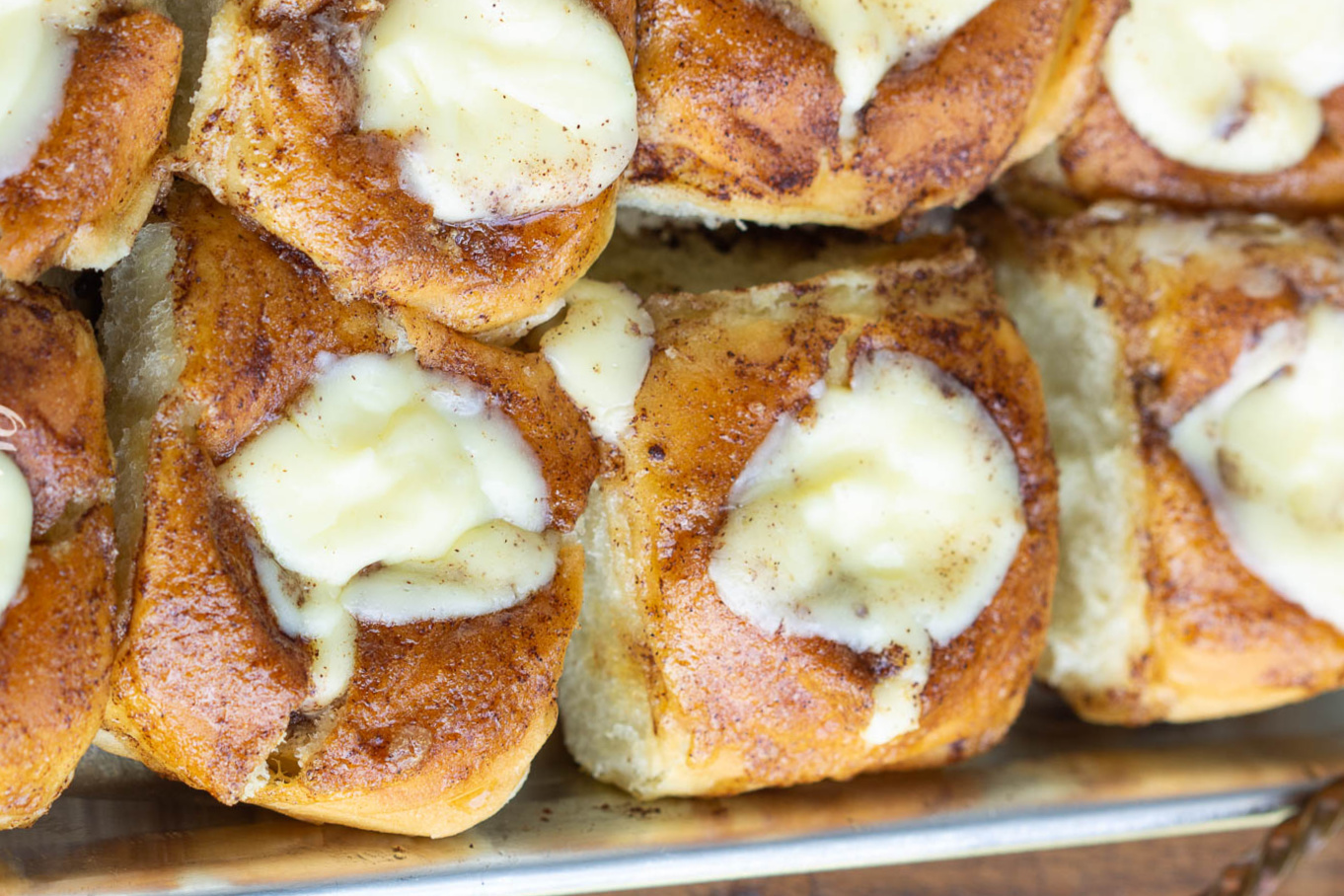 King's Hawaiian Cinnamon rolls with icing on a tray.