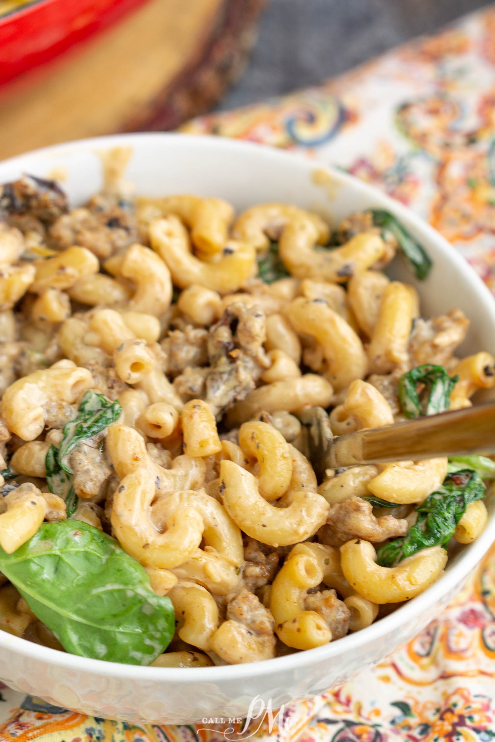A bowl of Italian Sausage Pasta with mushrooms and spinach.