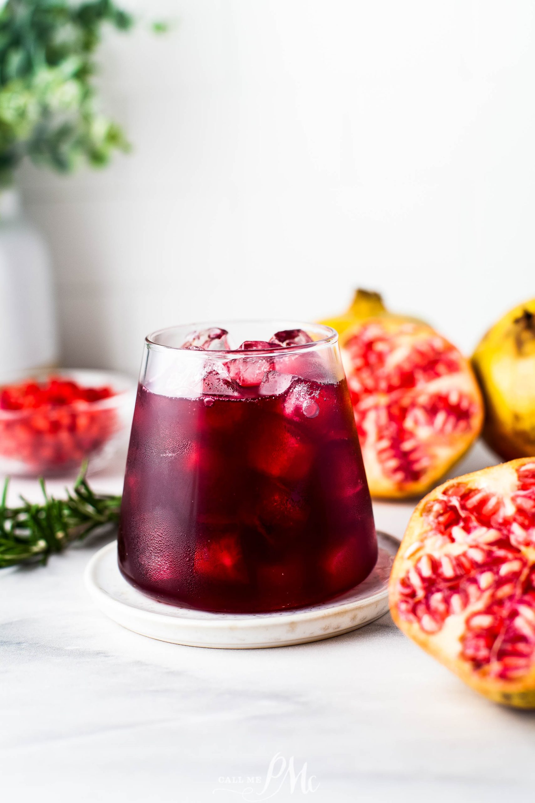 A festive Mistletoe Margarita garnished with a slice of pomegranate.