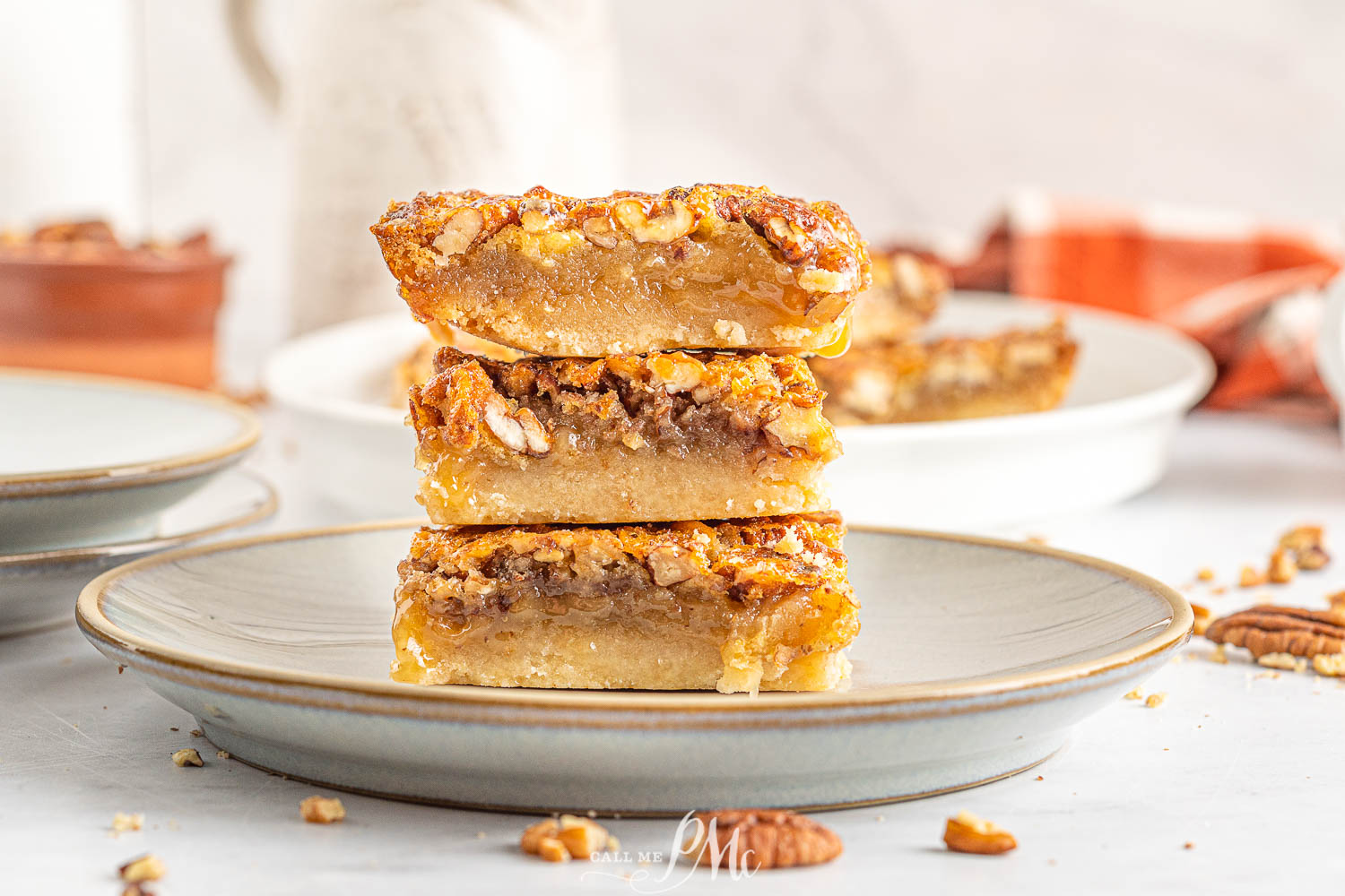 Pecan dessert squares stack on top of each other. 