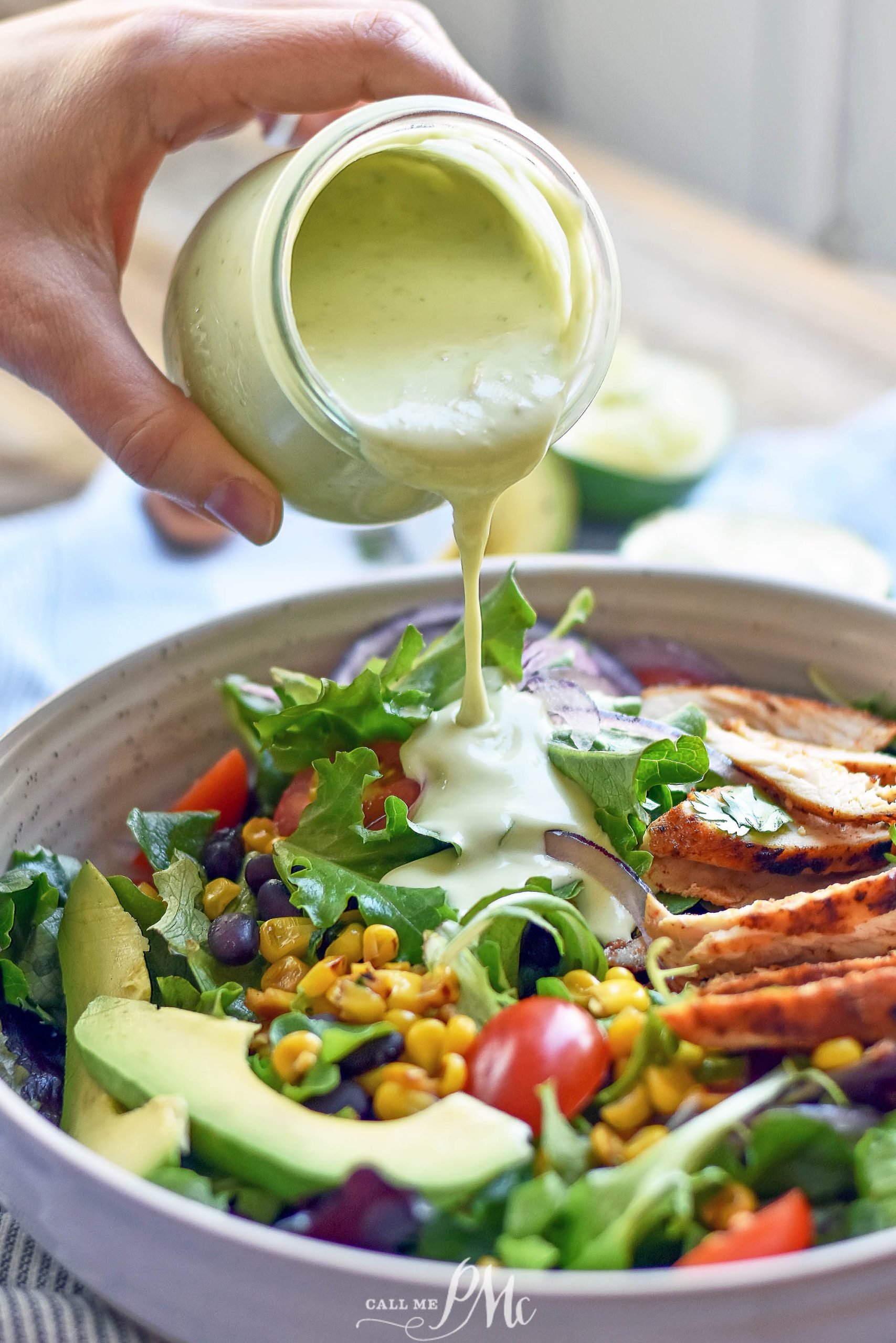 pouring avocado dressing over salad