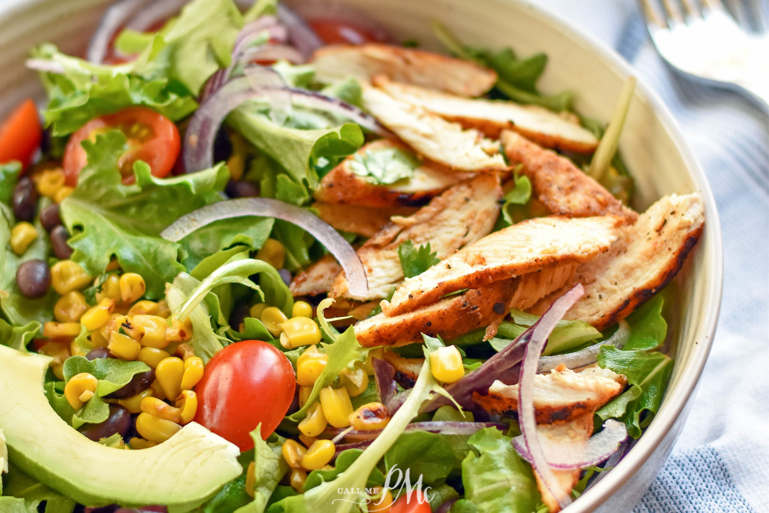 Blackened Chicken Salad with avocado sauce, lettuce, and tomato.