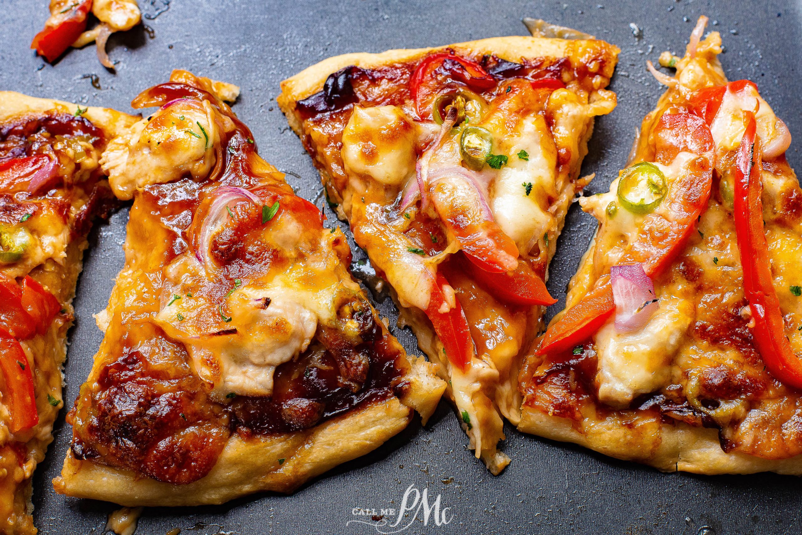 Four slices of pizza on a table.