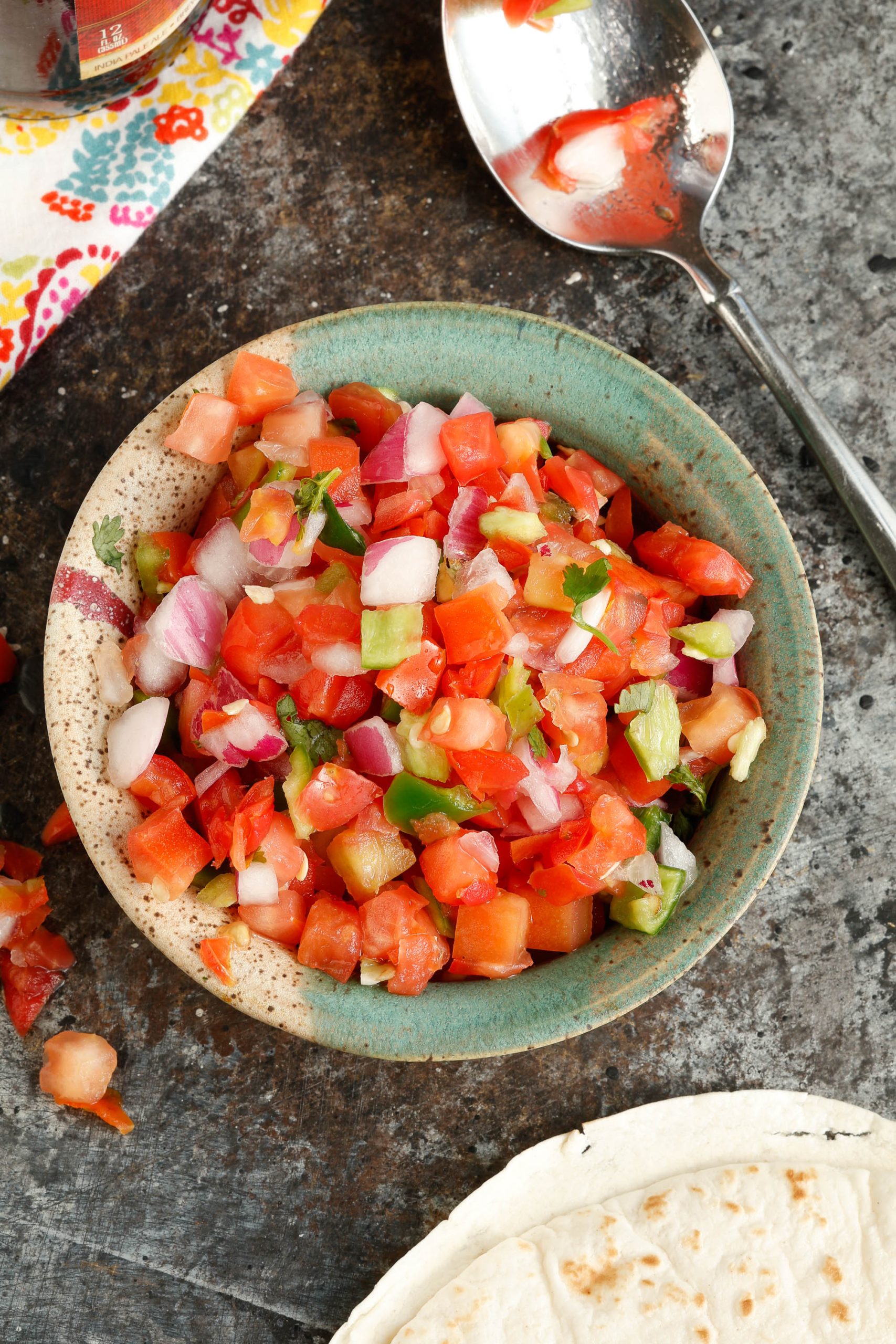 Chopped tomatoes, onion, and jalapeon in a bowl.