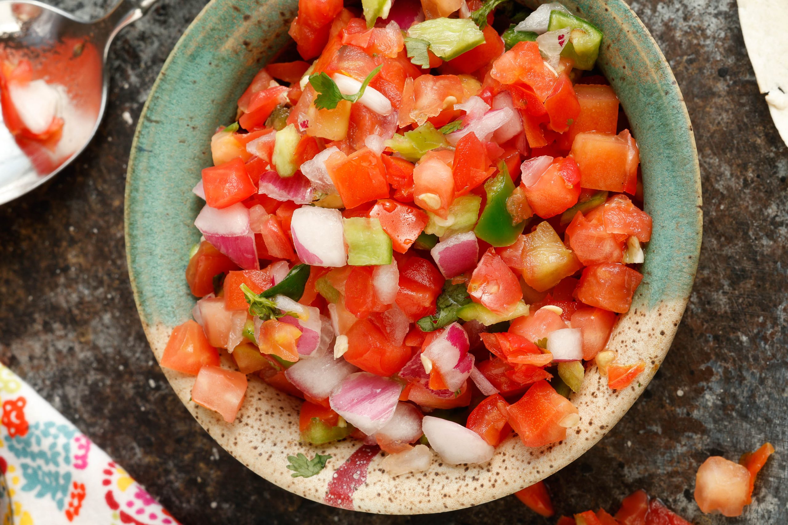 Chopped tomatoes, onion, and jalapeon in a bowl.