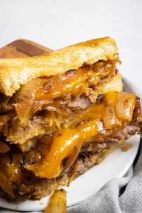 Chicken Fried Steak Patty Melt cut open with melty cheese.
