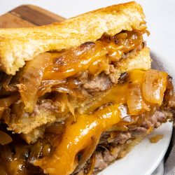 Chicken Fried Steak Patty Melt cut open with melty cheese.