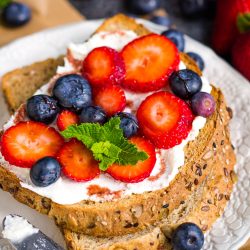 Date Syrup Drizzled Berry Ricotta Toast on plate.