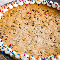 A giant chocolate chip cookie decorated around the edge
