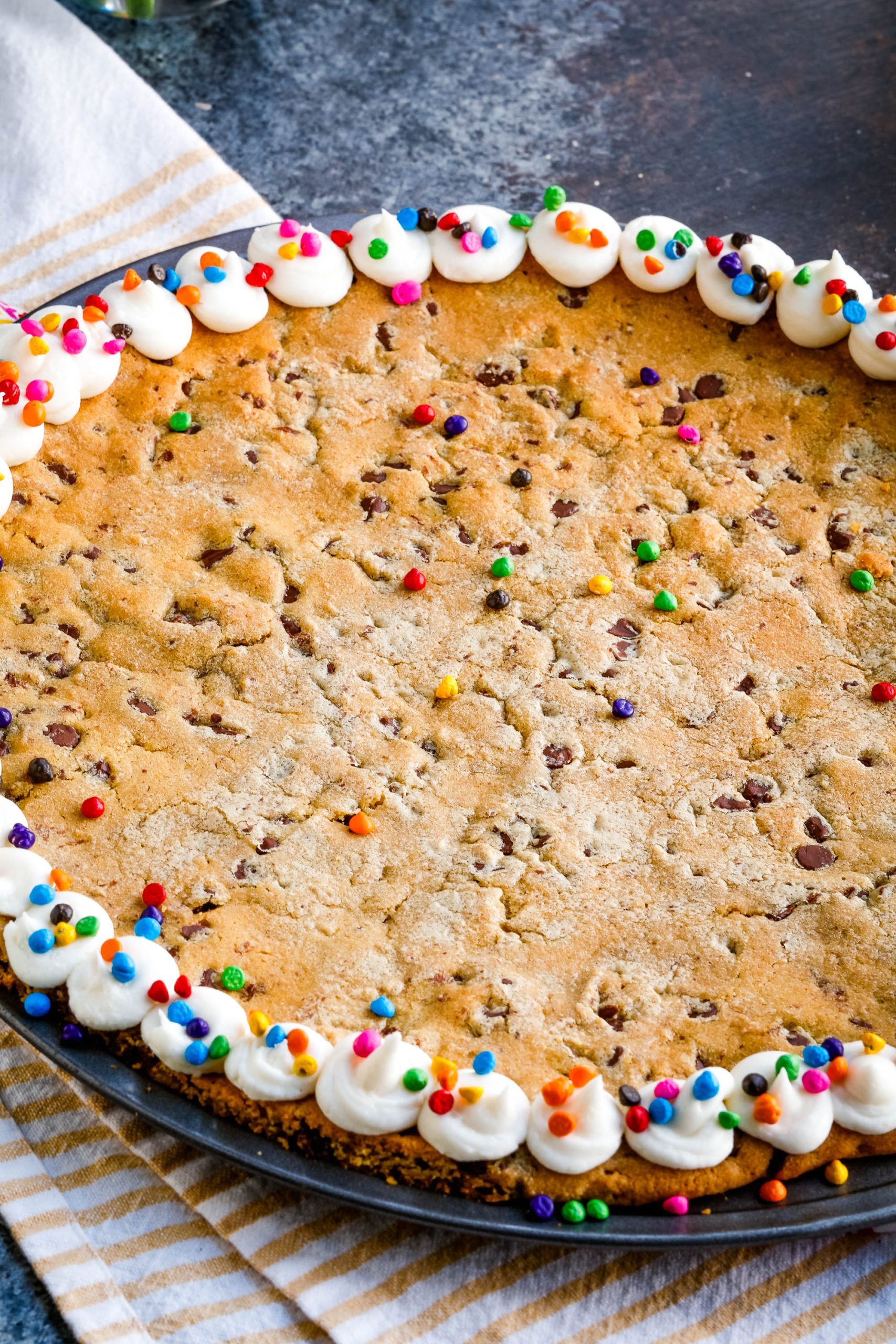 A giant chocolate chip cookie decorated around the edge