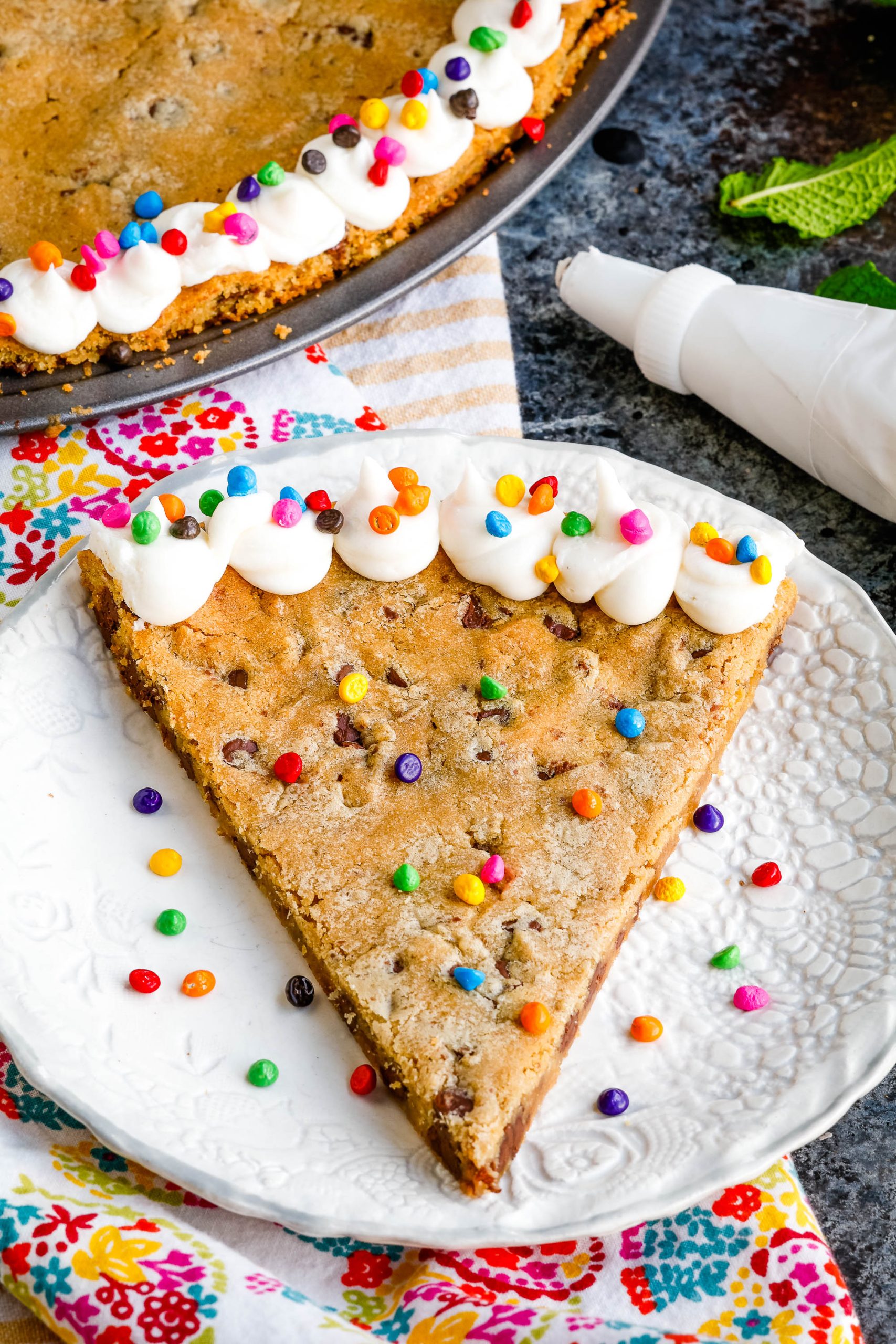 A slice out of a giant chocolate chip cookie.