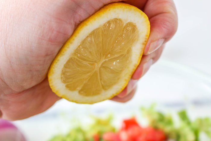 half lemon being squeezed