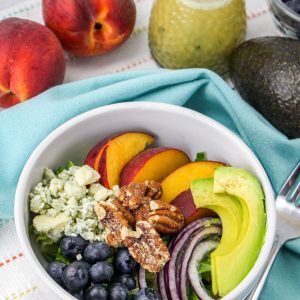 fruit and peaches in a bowl