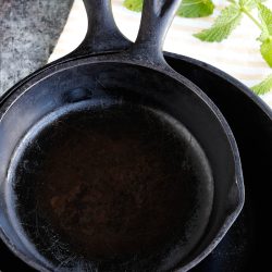 Two seasoned cast iron skillets.