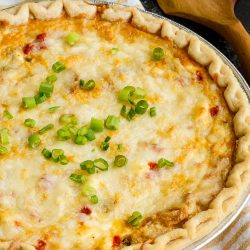 Close up of whole chicken quiche on table.