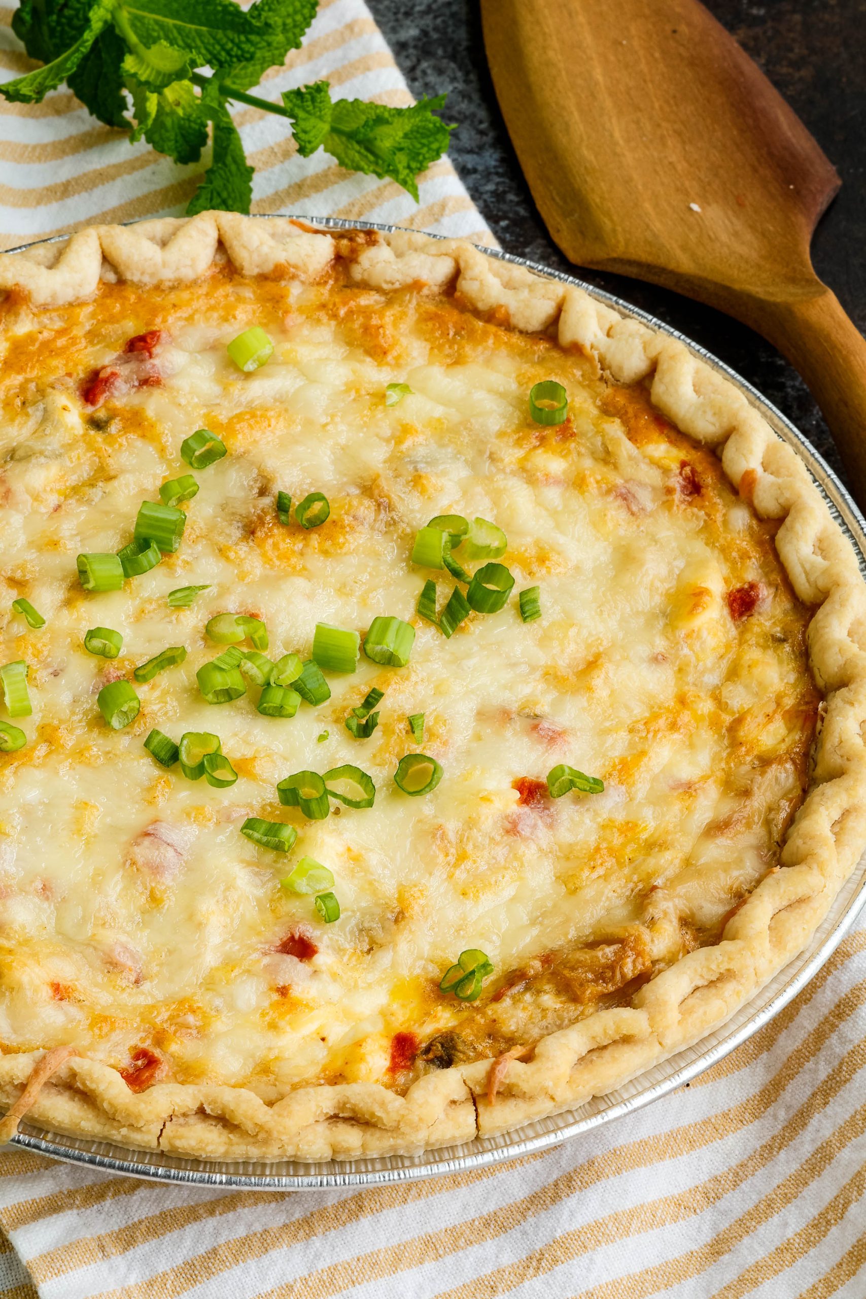 Close up of whole chicken quiche on table.