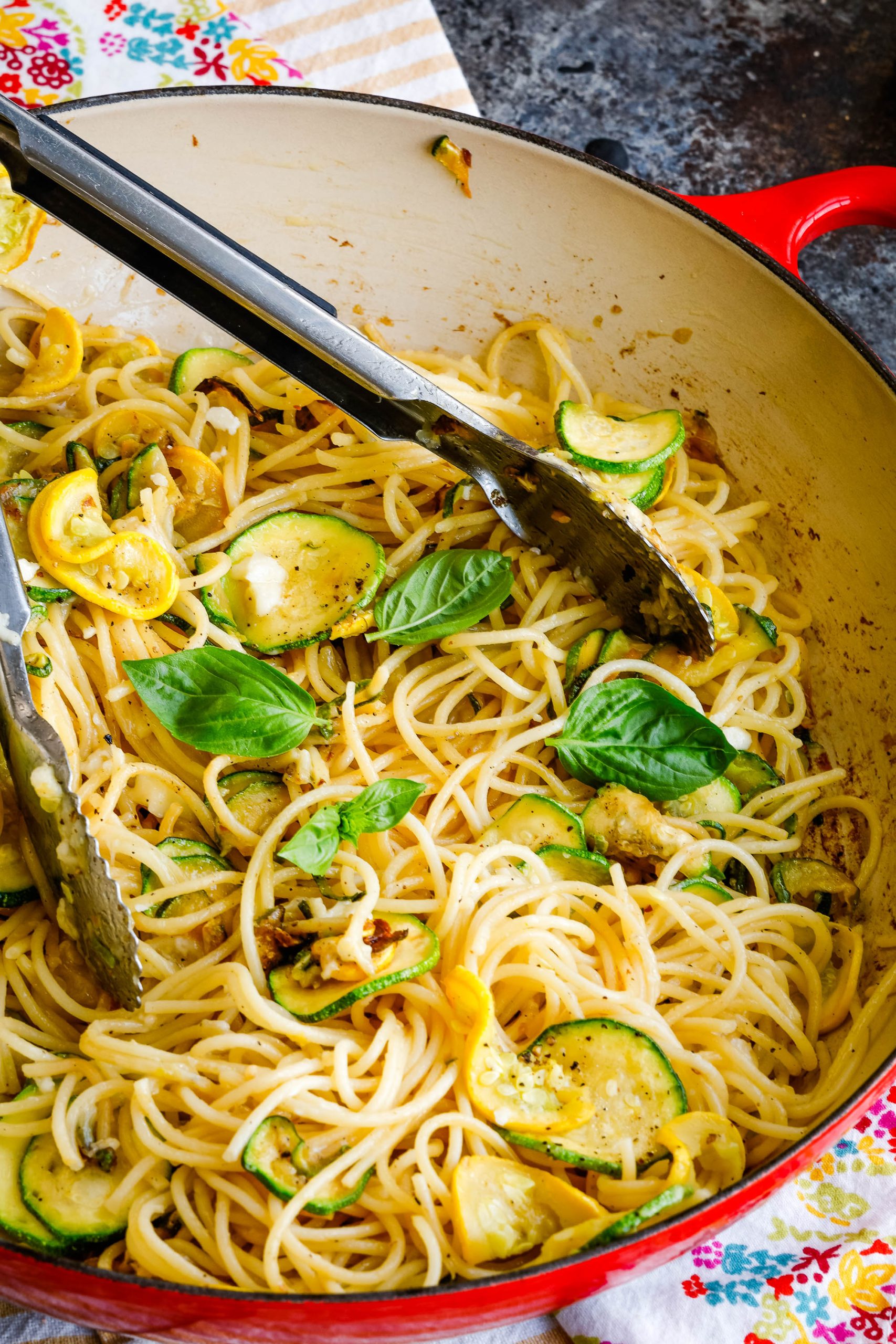 zucchini and squash with spaghetti noodles in a pan