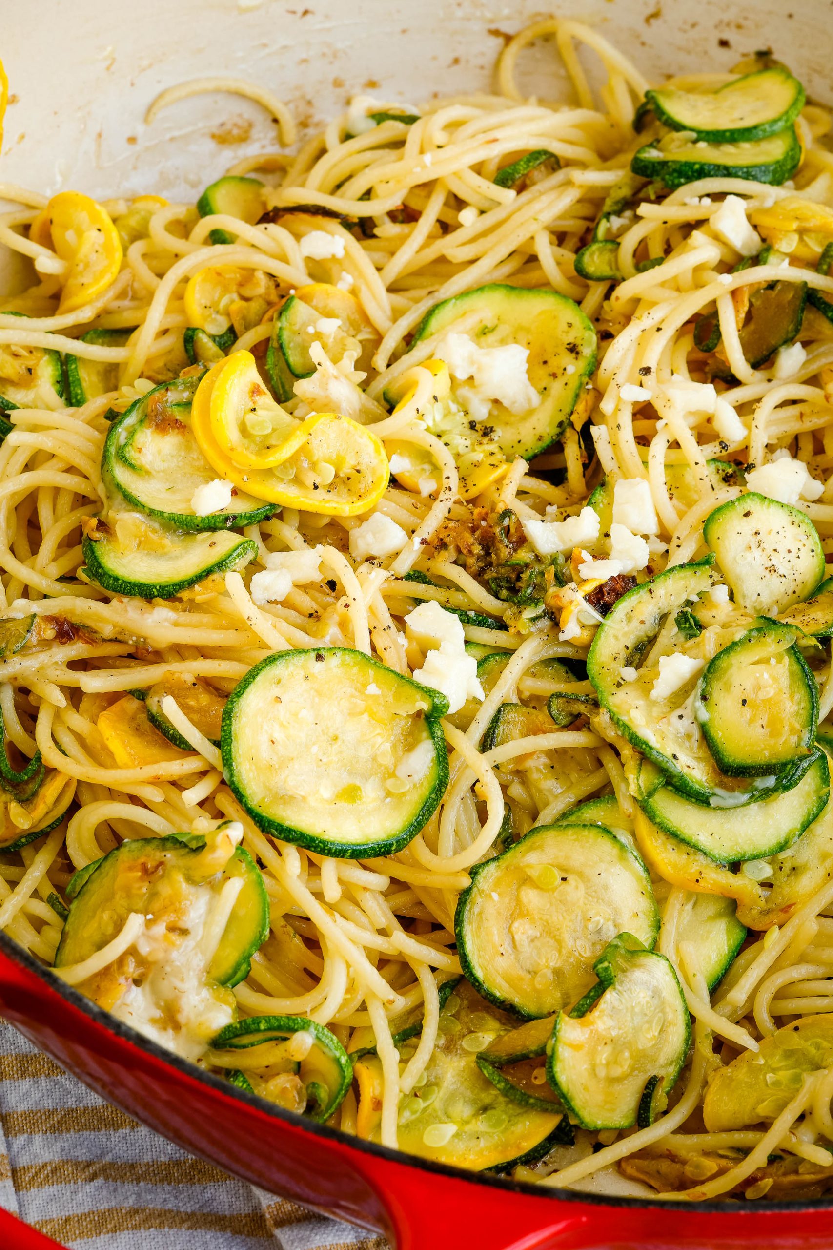 Zucchini Squash slice with noodles in a pan.
