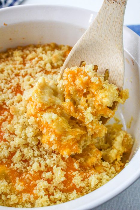 Baked Velveeta Mac and Cheese in a bowl being stirred.