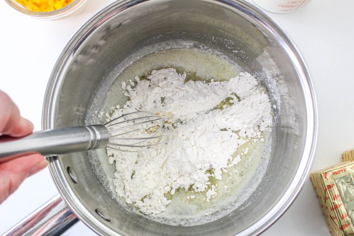 Making a white sauce with butter and flour.