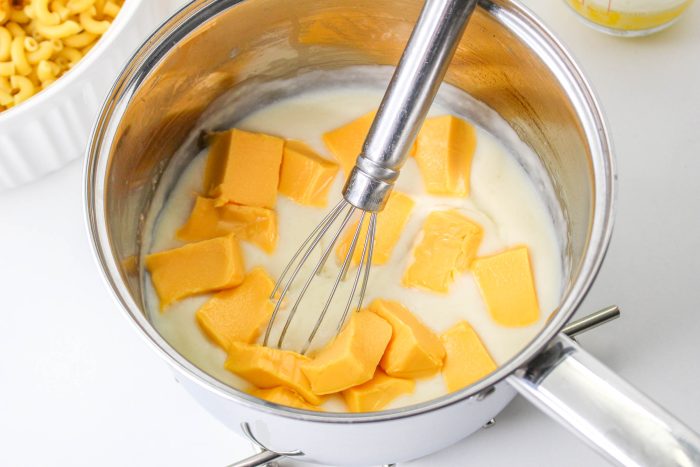 Melting cheese chunks in milk.