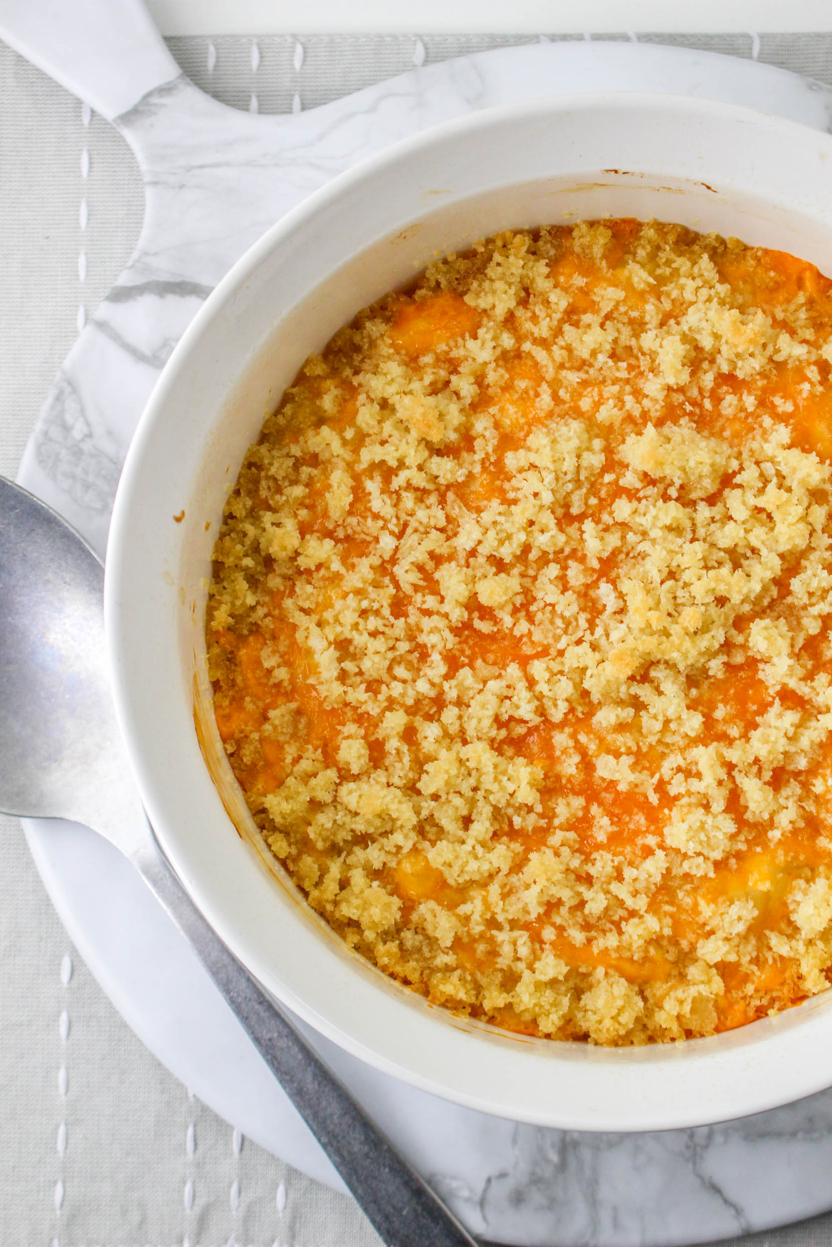Flatlay of casserole with cheese and breadcrumbs.