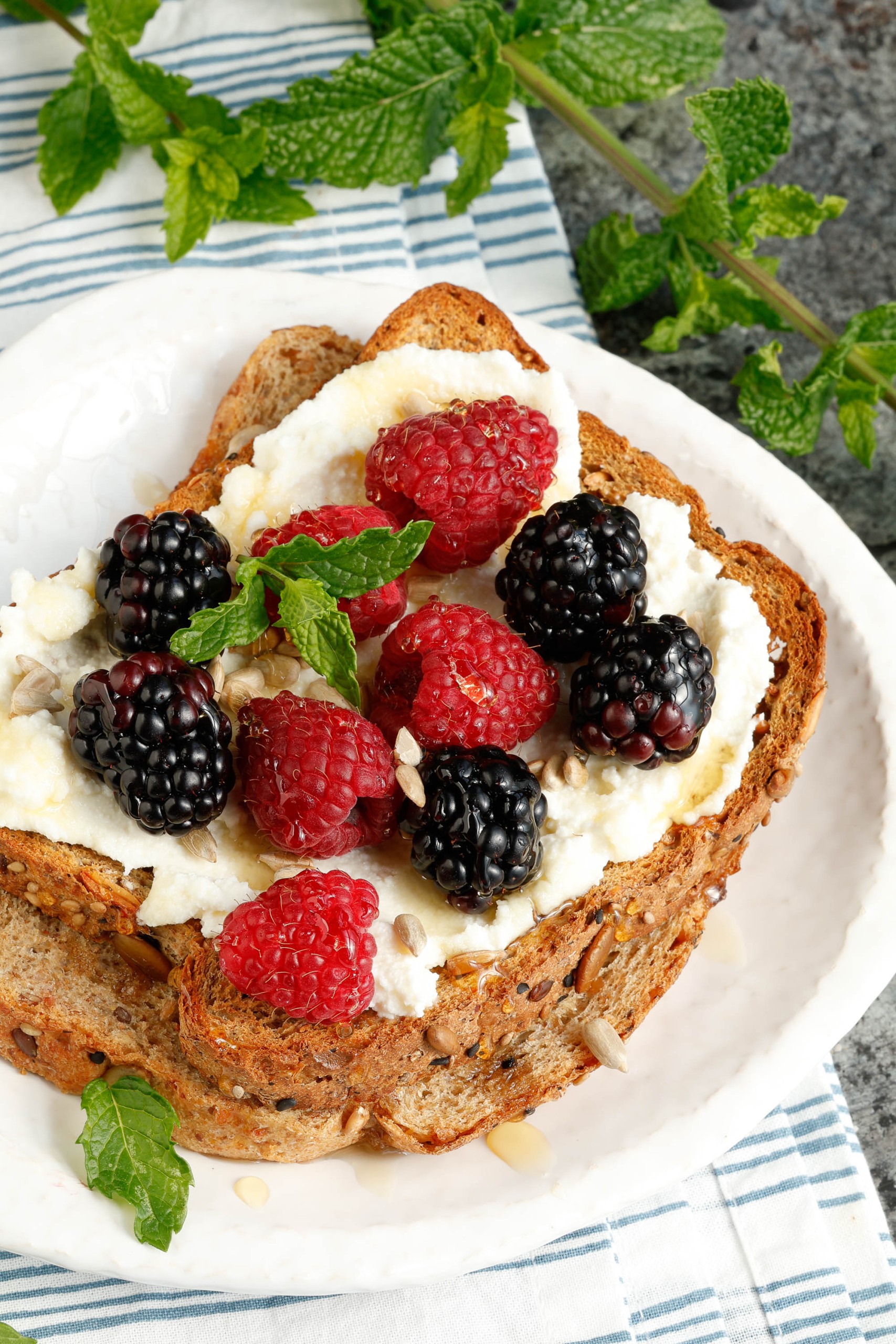 Blackberries and raspberries on toast with ricotta.