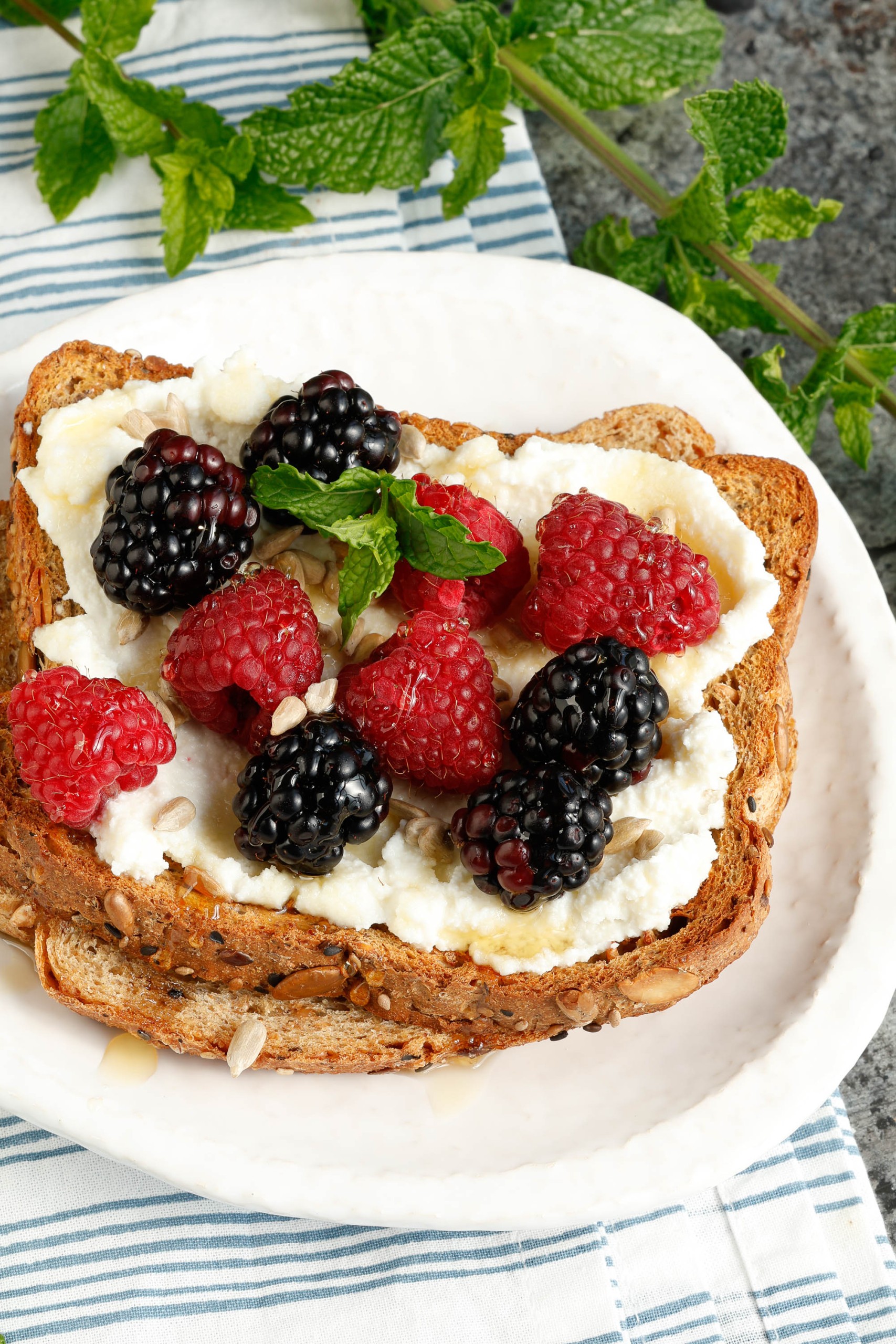 Blackberries and raspberries on toast with ricotta.