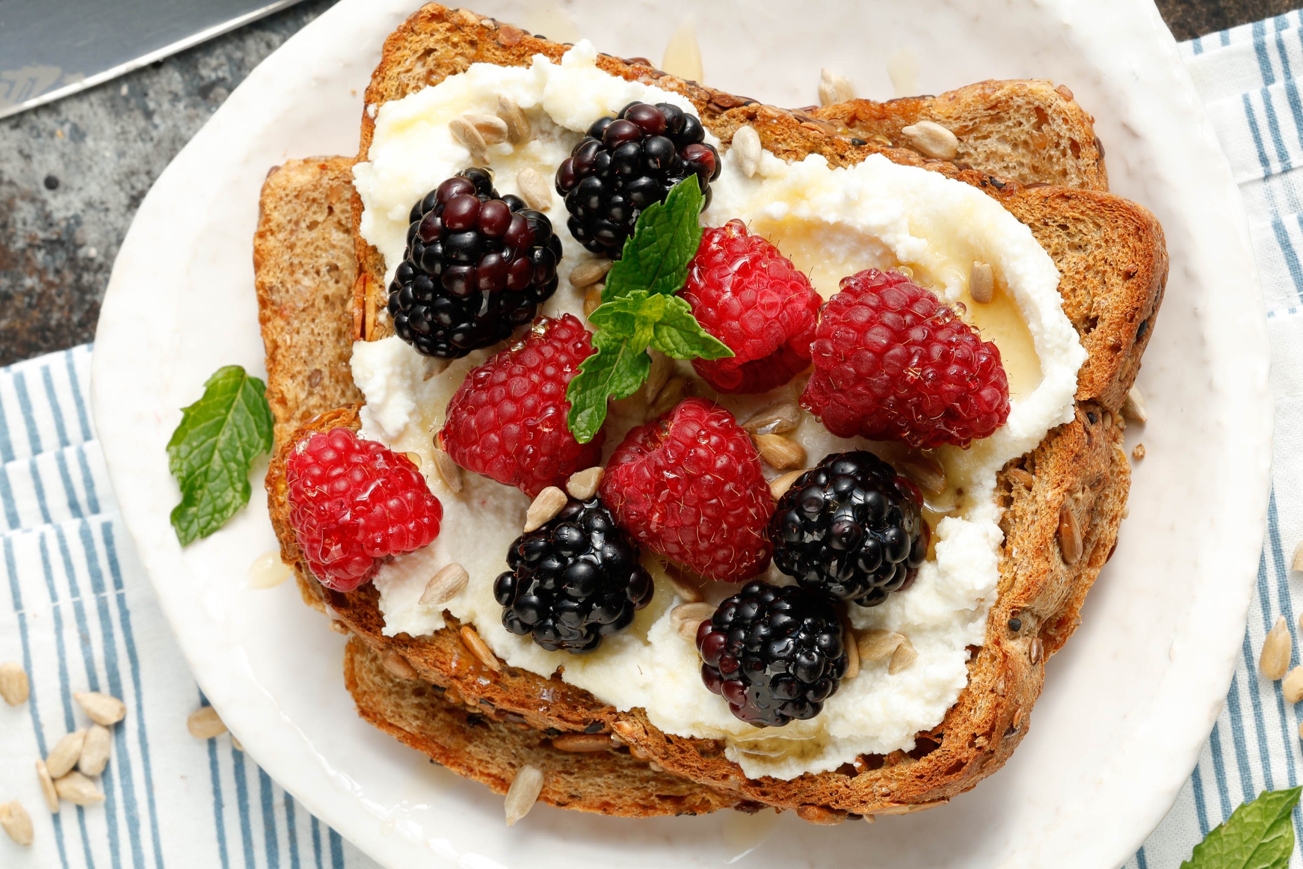 Berries and toasted sourdough on a plate.