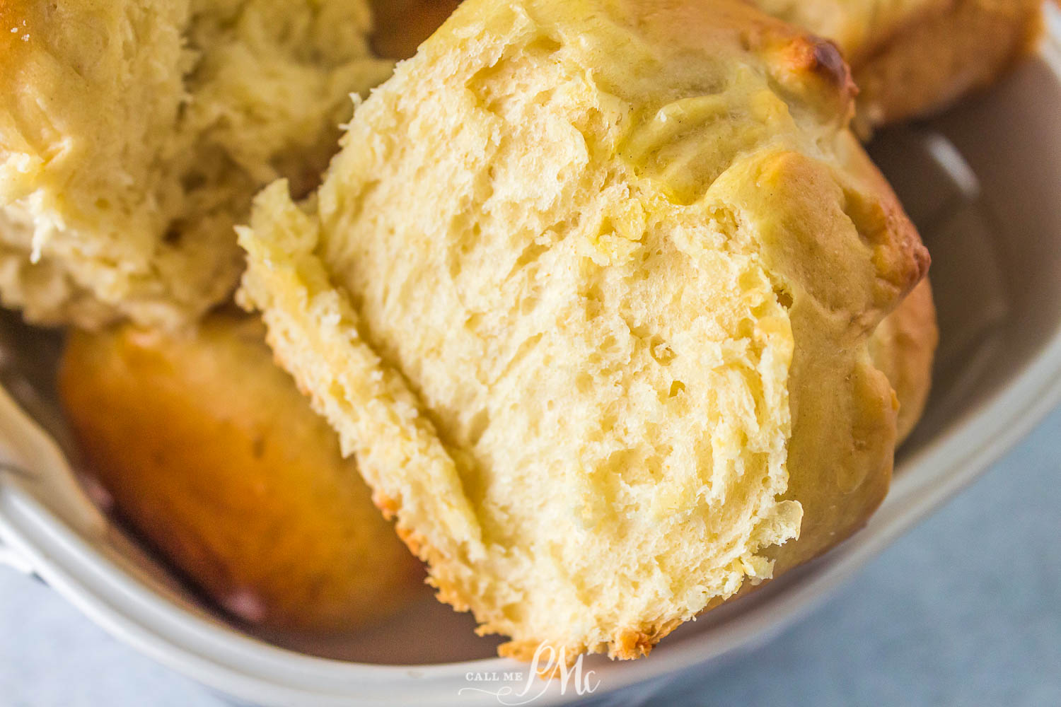 Brioche rolls in a whilte bowl.