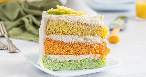 Slice of Ombre Citrus Layer Cake on saucer.