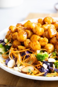 Bay scallops on bed of greens.