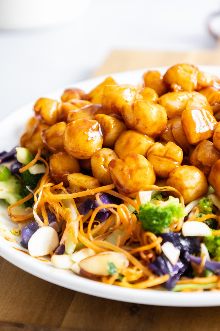 Bay scallops on bed of greens.