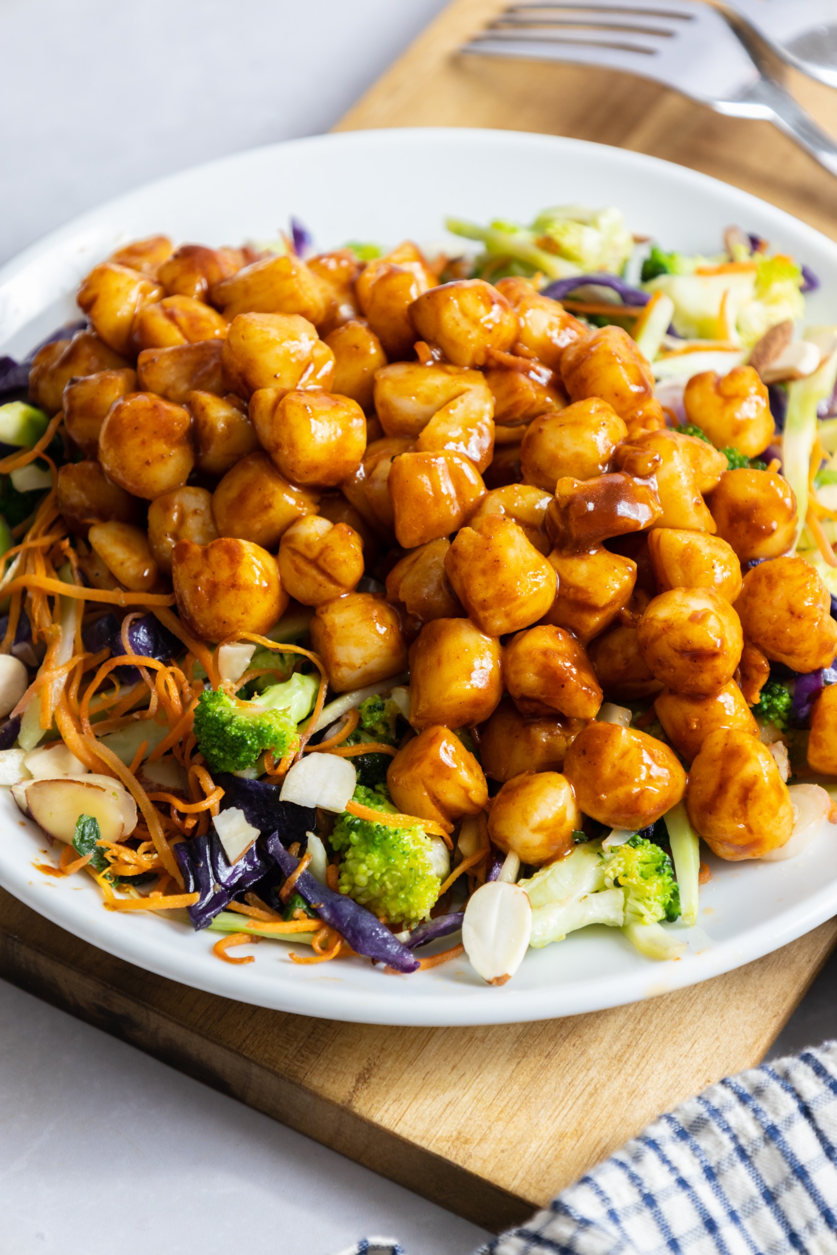 Bay scallops on bed of greens.