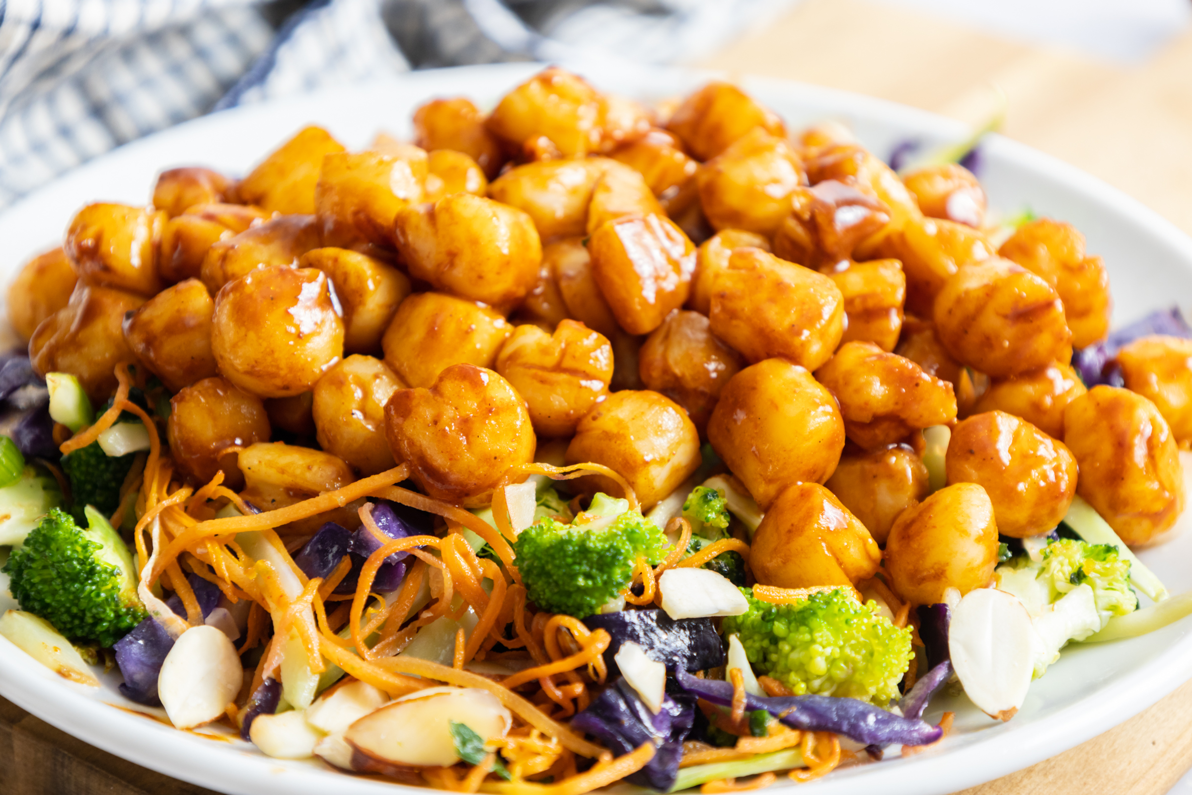 Hoisin Glazed Scallops, Bay scallops on bed of broccoli slaw.