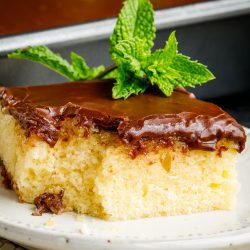 Hot Milk Cake with chocolate icing on plate.