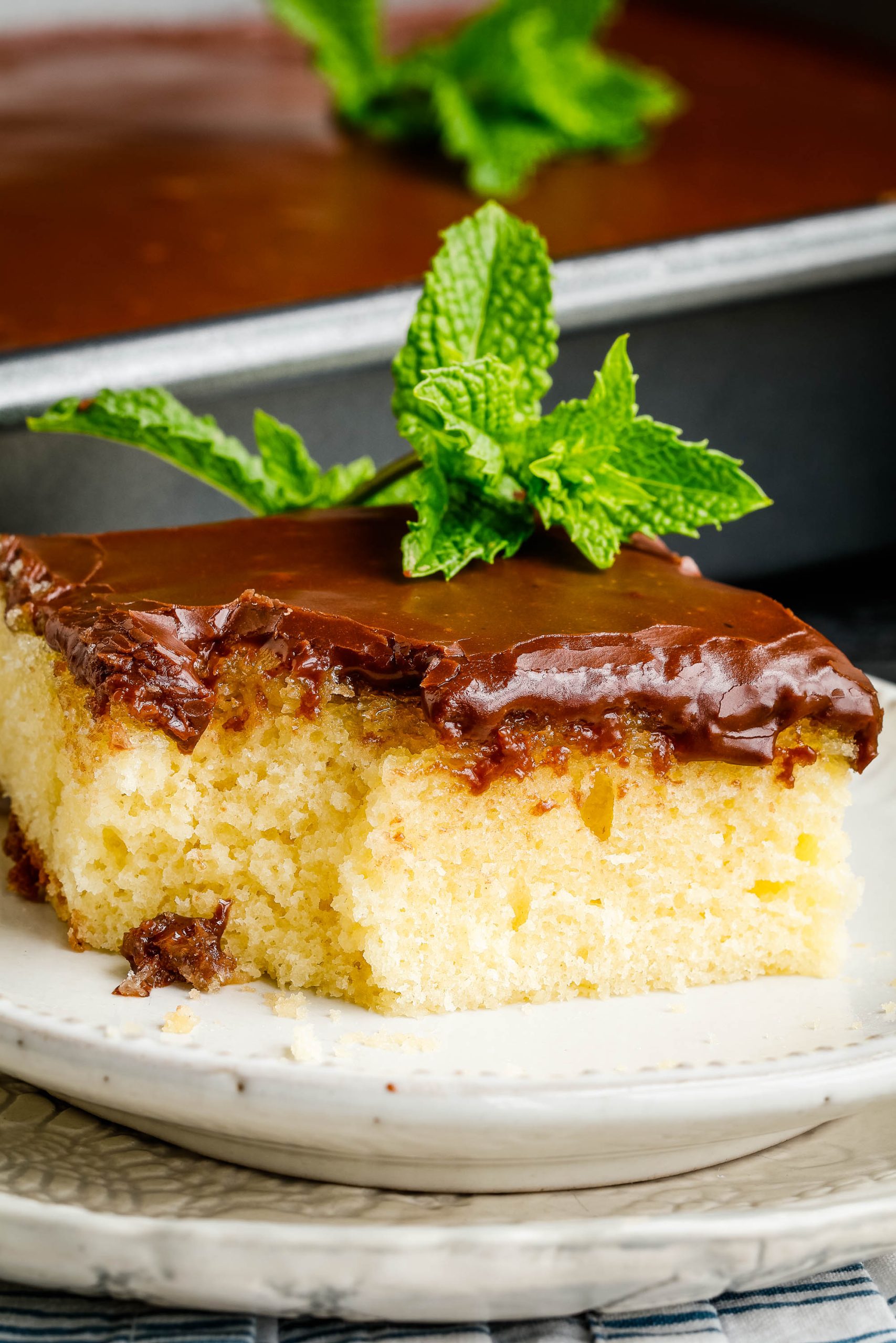 Hot Milk Cake with chocolate icing on plate.