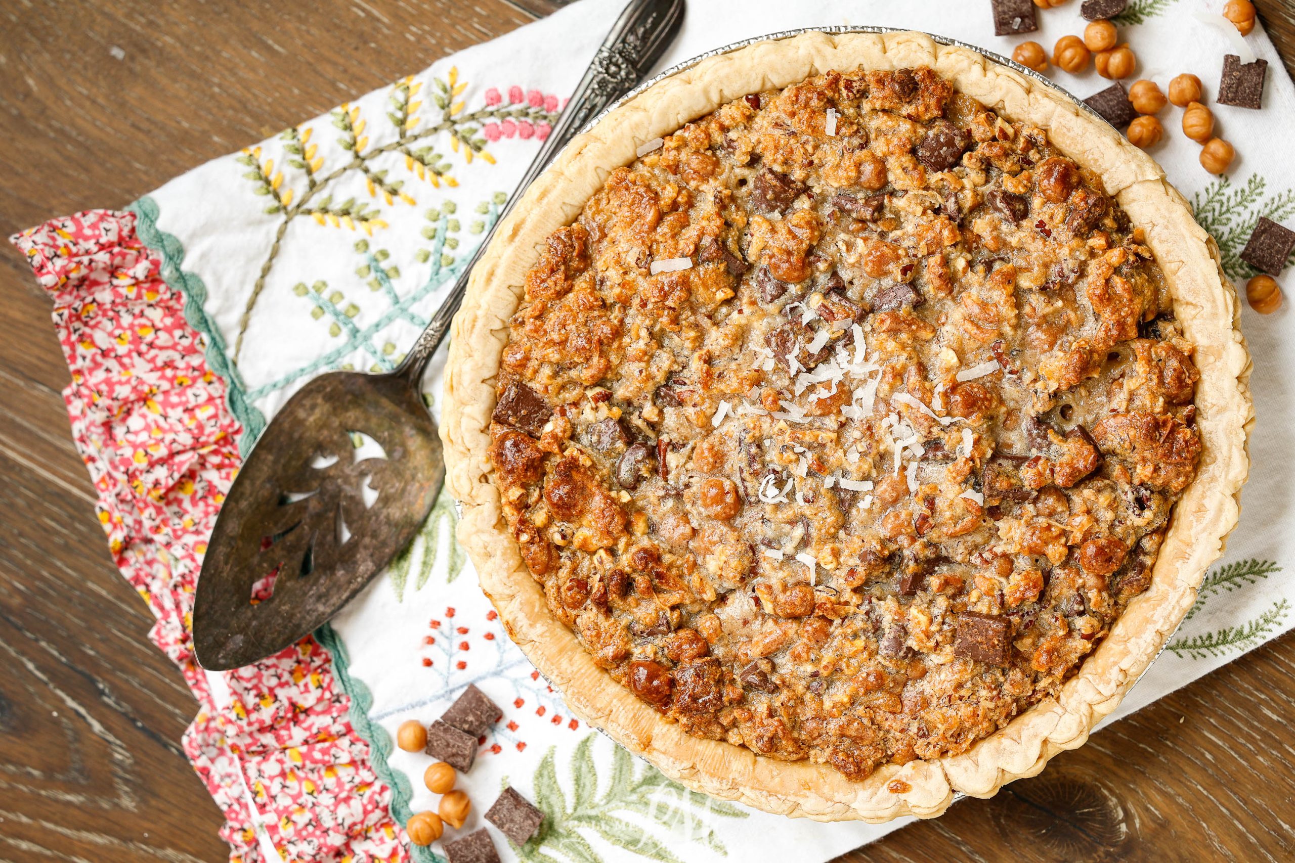 Flat lay of whole pie with chocolate and caramel.