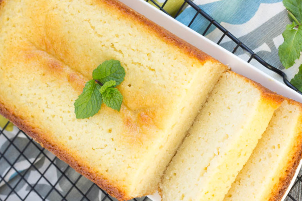 Pound cake loaf on a wire rack with slices cut.