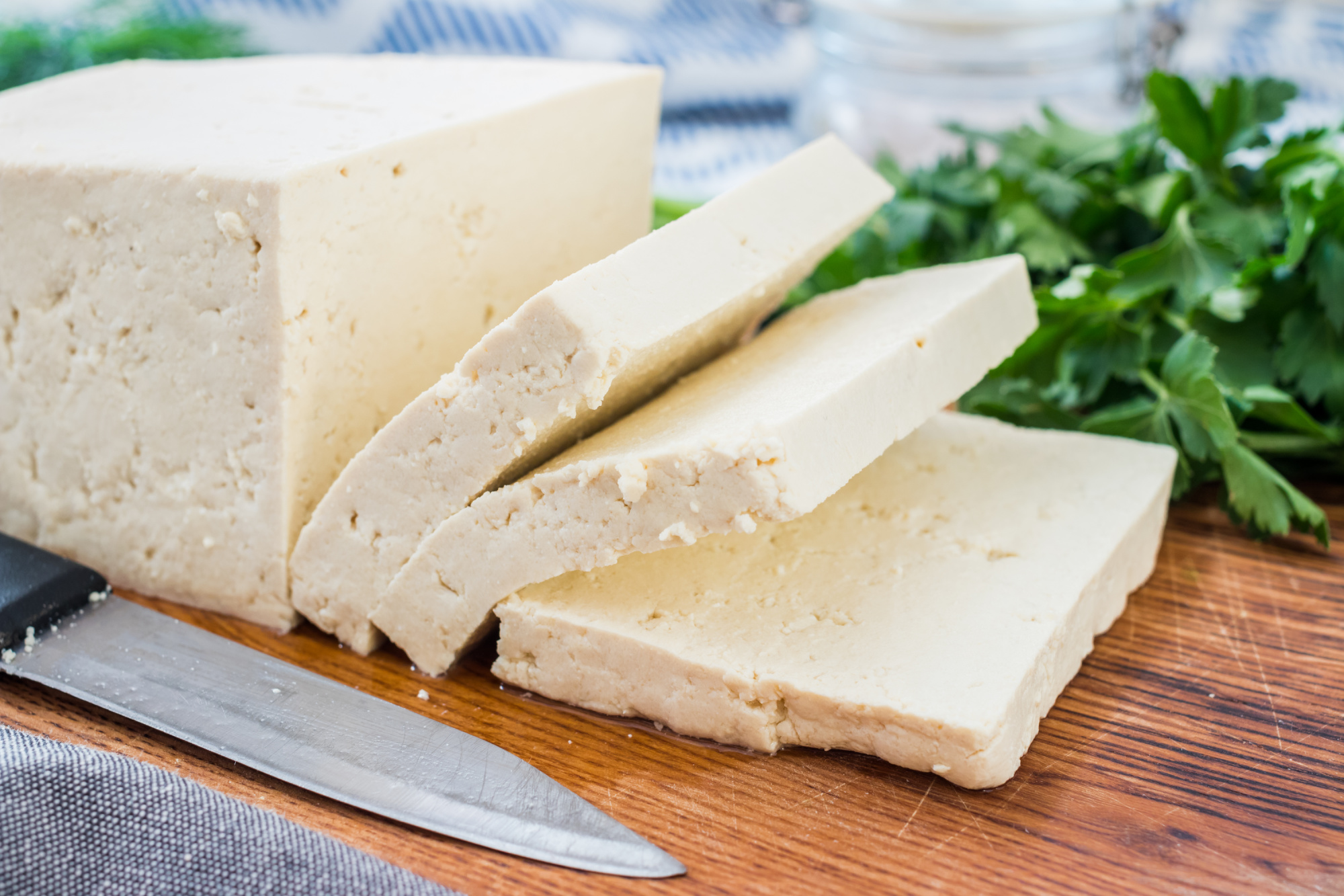 Slices of tofu on a cutting board.