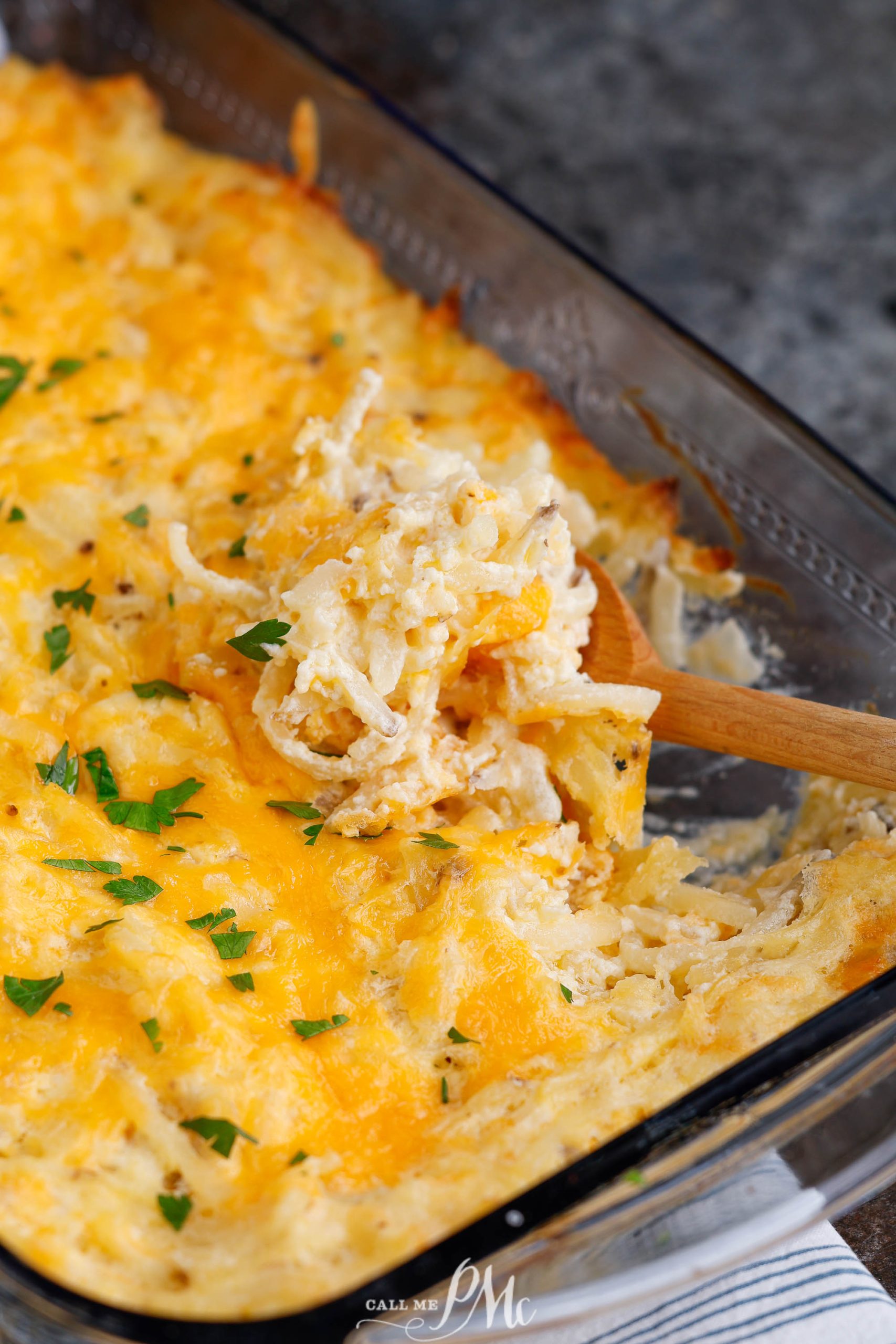 Cheesy hashbrown casserole in a pan.